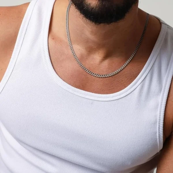 Hombre con cadena de acero inoxidable plateada, usando camiseta blanca.