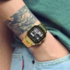 Reloj digital Q&Q dorado en la muñeca con outfit casual